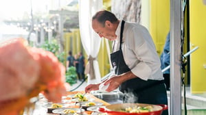 Charlie Palmer plates food for Spring Celebration Dinner